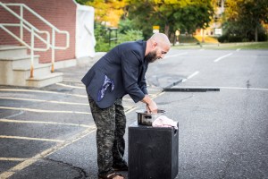 Rinses hands 20 seconds and uses cloth on box to dry.